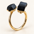Steady Ground adjustable gold-tone ring with two black tourmaline stones on an ivory background