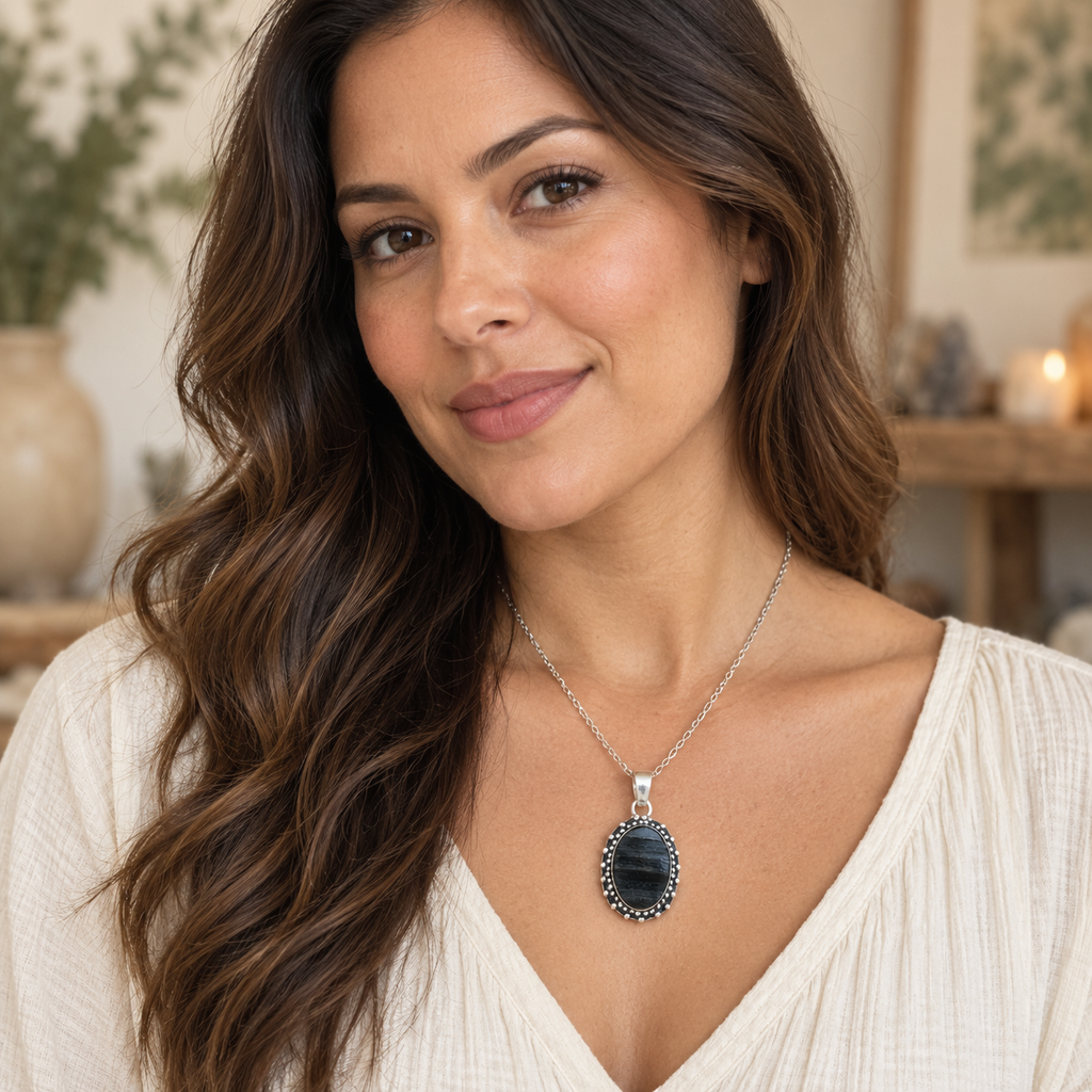 Model wearing a medium oval black tourmaline pendant on a silver-tone chain.