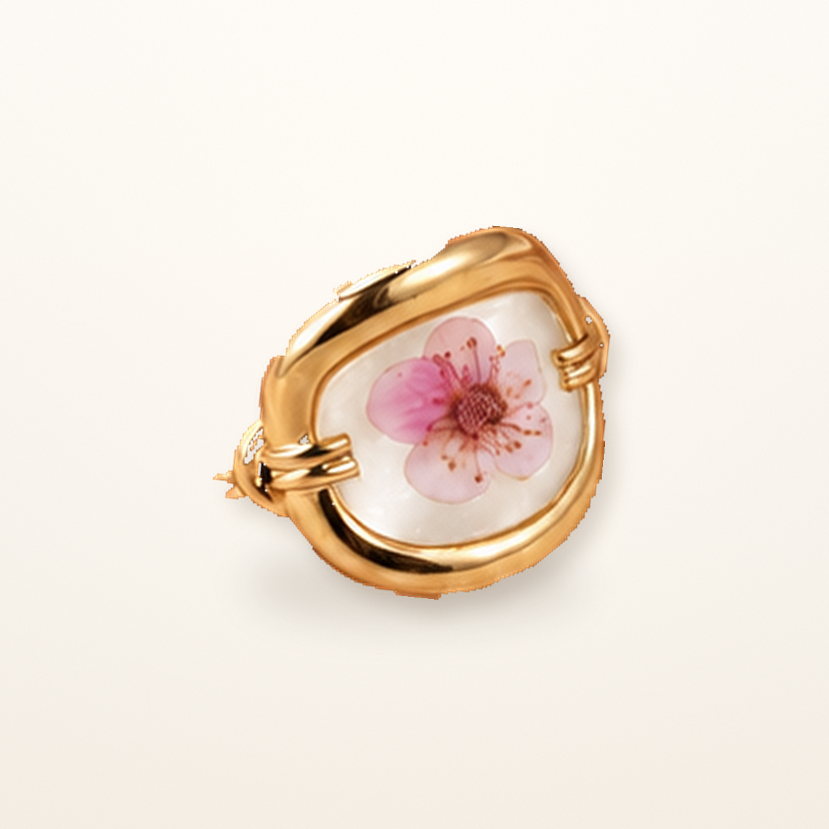 Blush Blossom Becoming Ring with a preserved pink flower on a white resin background in a gold-tone setting