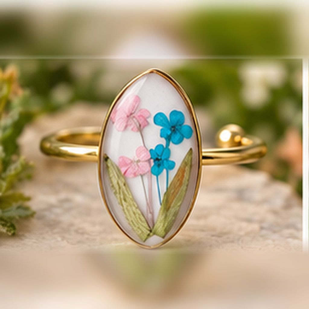 Gentle Beginnings adjustable stainless steel pressed-flower ring with pink and blue blossoms.