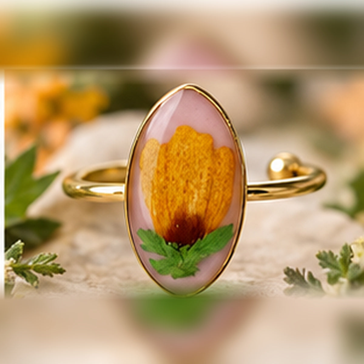 Golden Bloom adjustable stainless steel pressed-flower ring with a golden orange flower on soft blush.