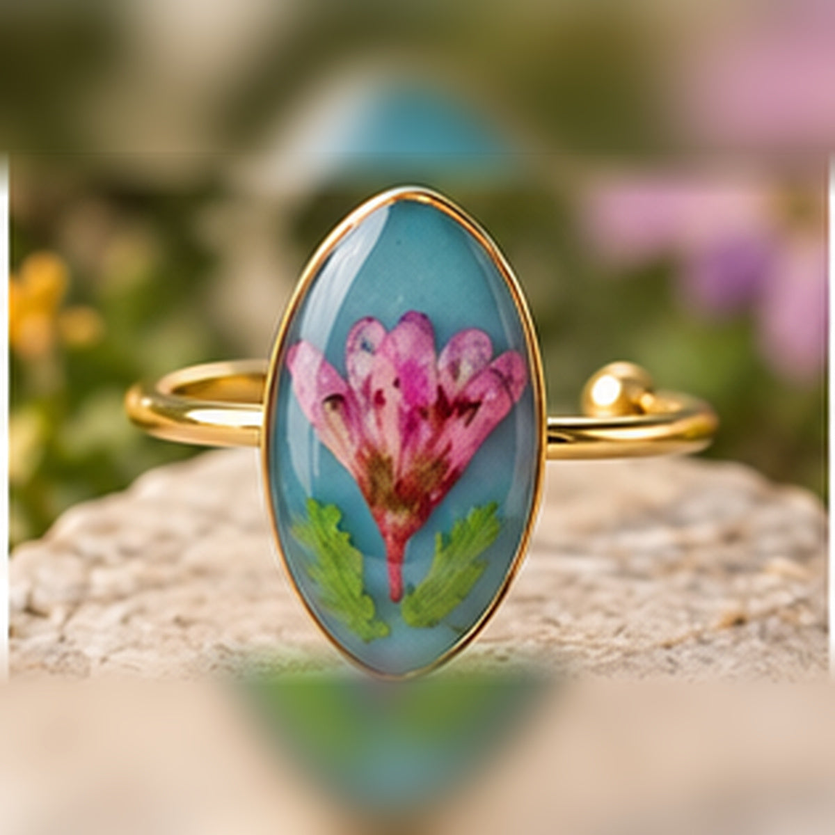 Heart Bloom adjustable stainless steel pressed-flower ring with a pink bloom on turquoise.
