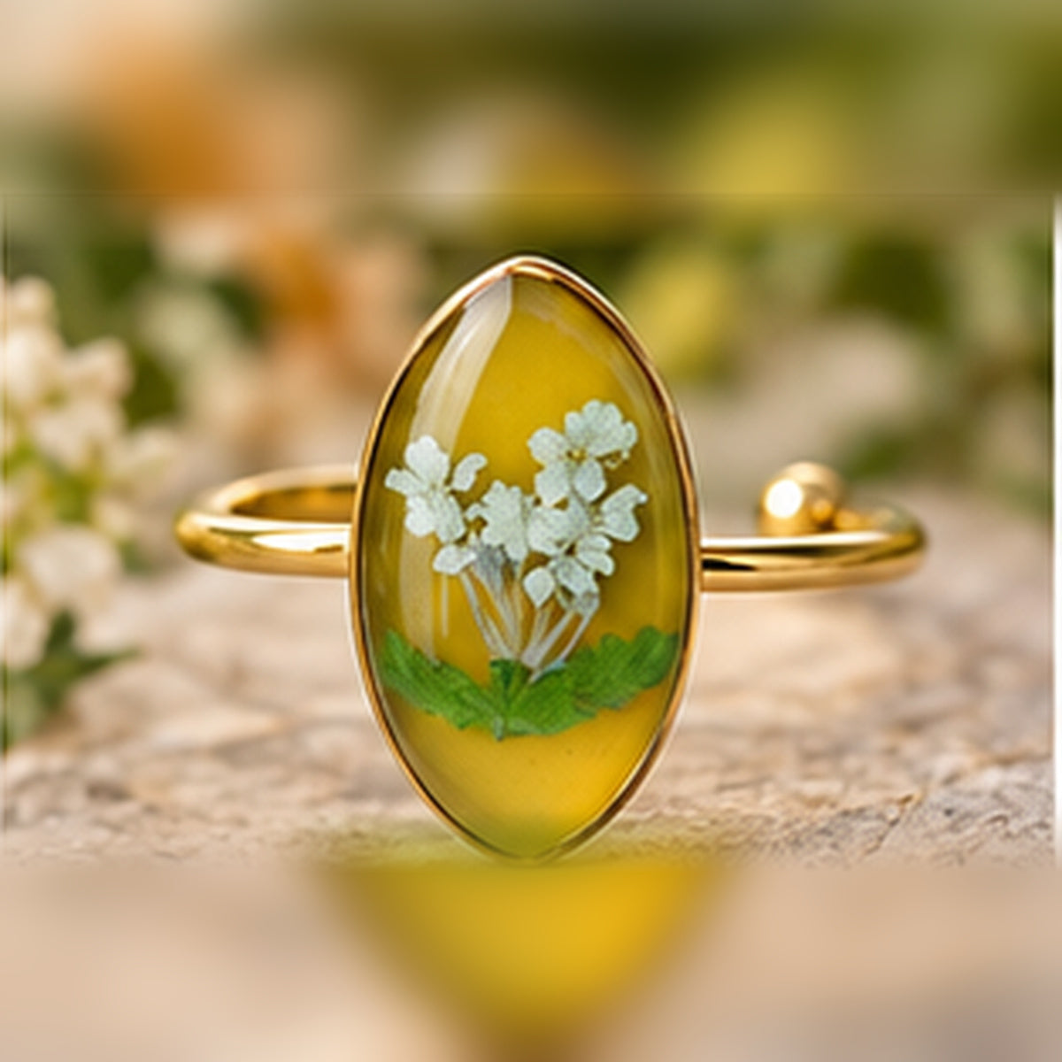 Meadow Lace adjustable stainless steel pressed-flower ring with white lace-like flowers on golden yellow.