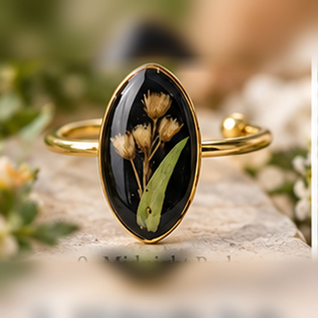 Midnight Buds adjustable stainless steel pressed-flower ring with muted golden buds on black.