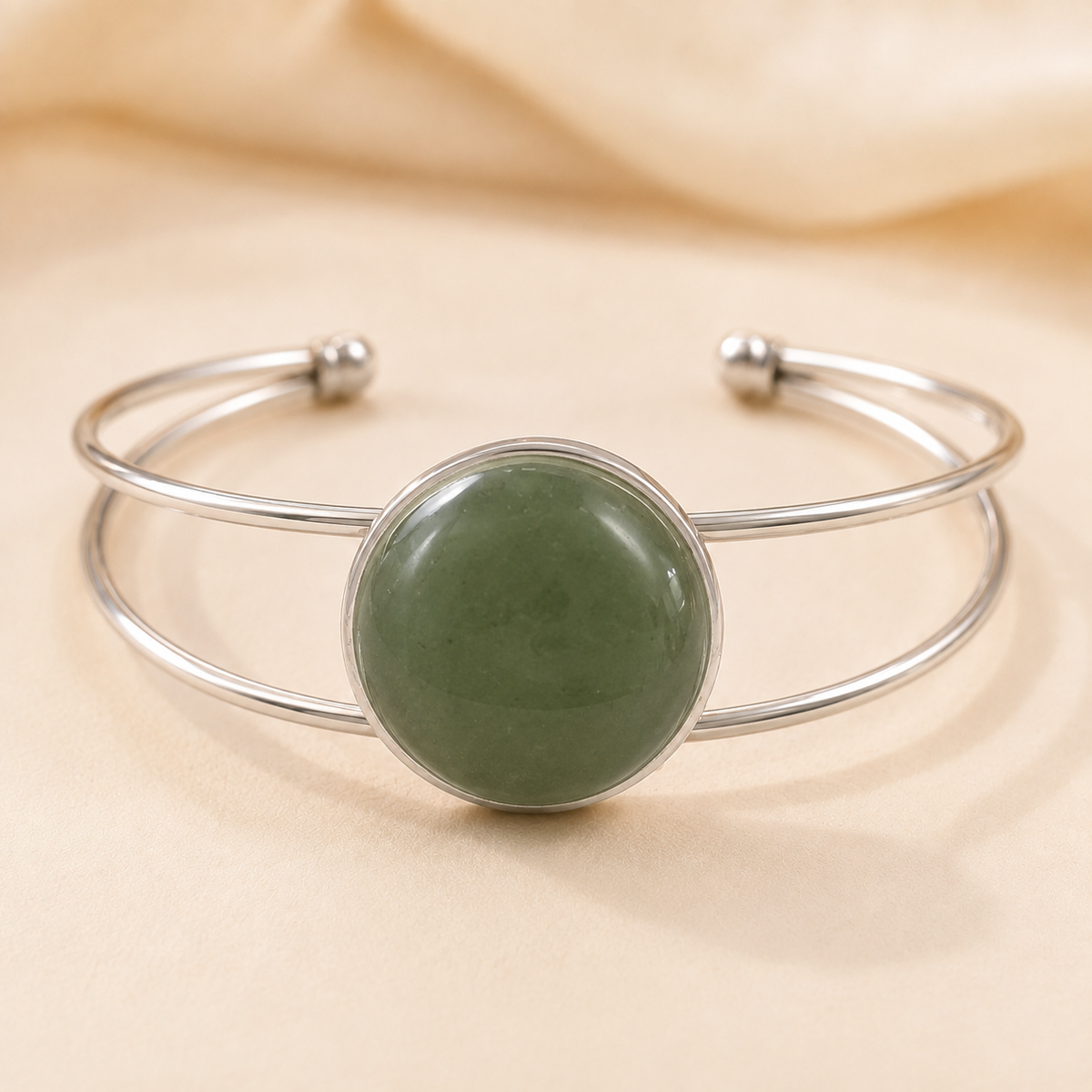 Moonlit Magic silver double-band bangle with a round green stone.