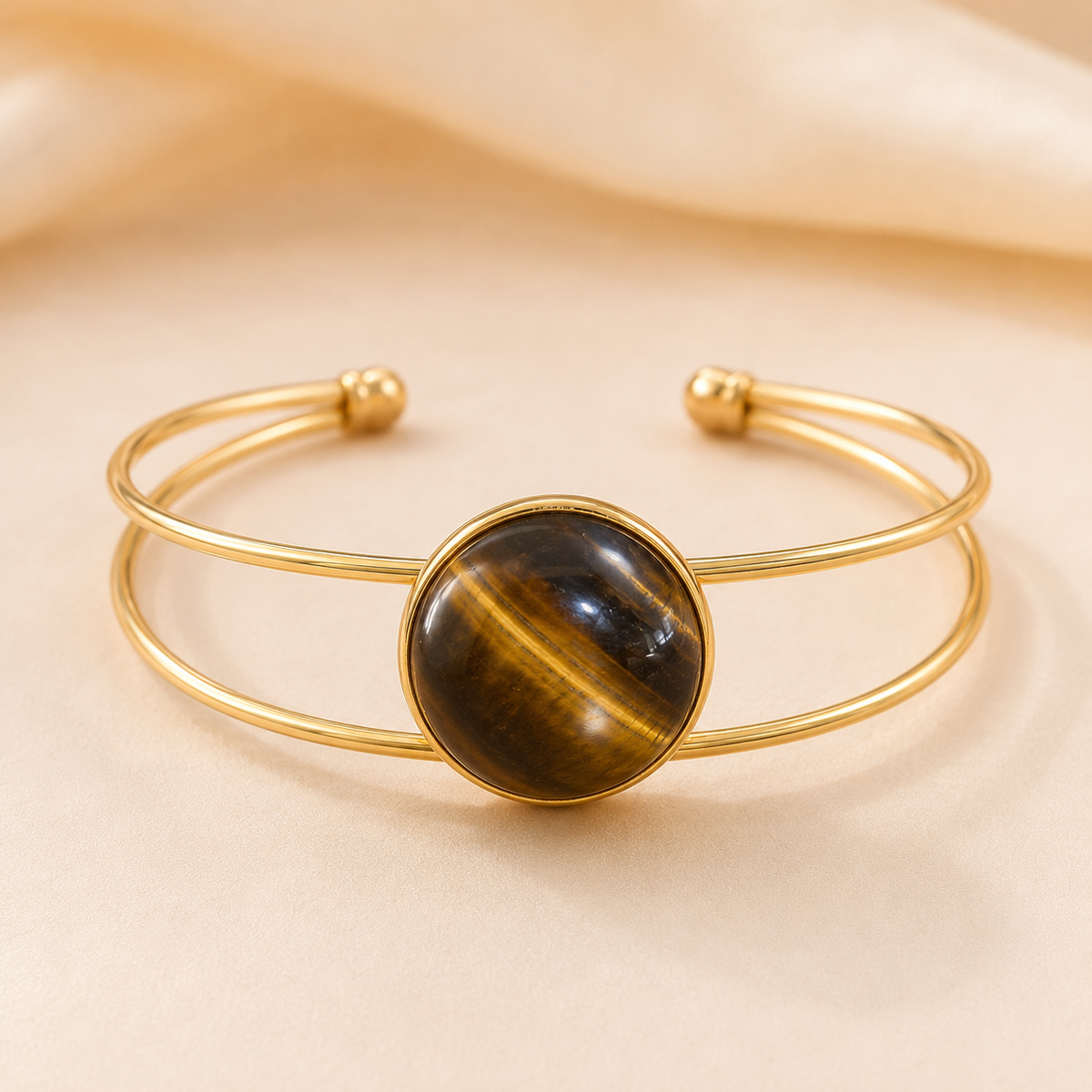 Golden Horizon gold-tone double-band bangle with a round Tiger’s Eye stone.