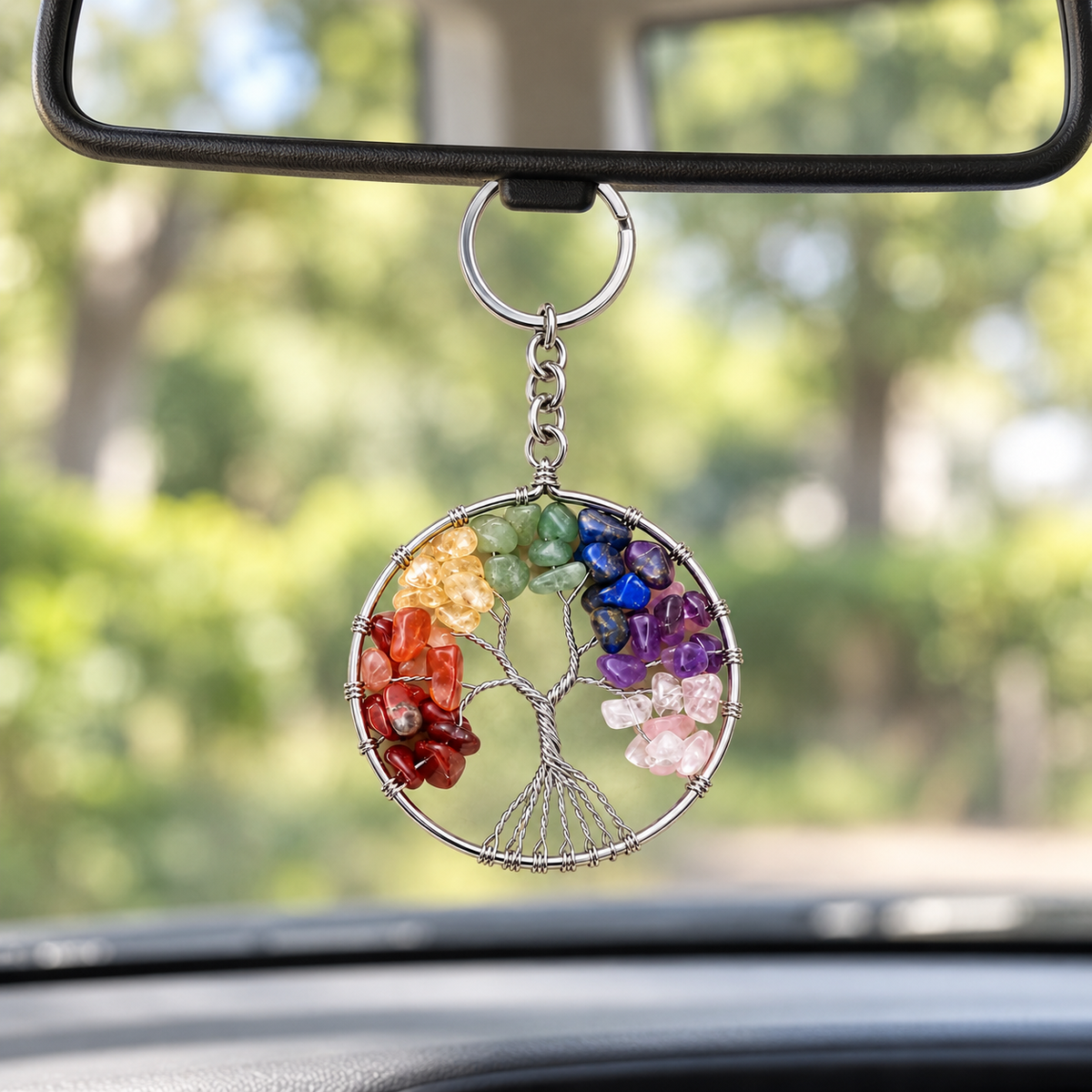 Radiant Roots Rainbow Tree of Life gemstone keychain hanging from a rearview mirror.
