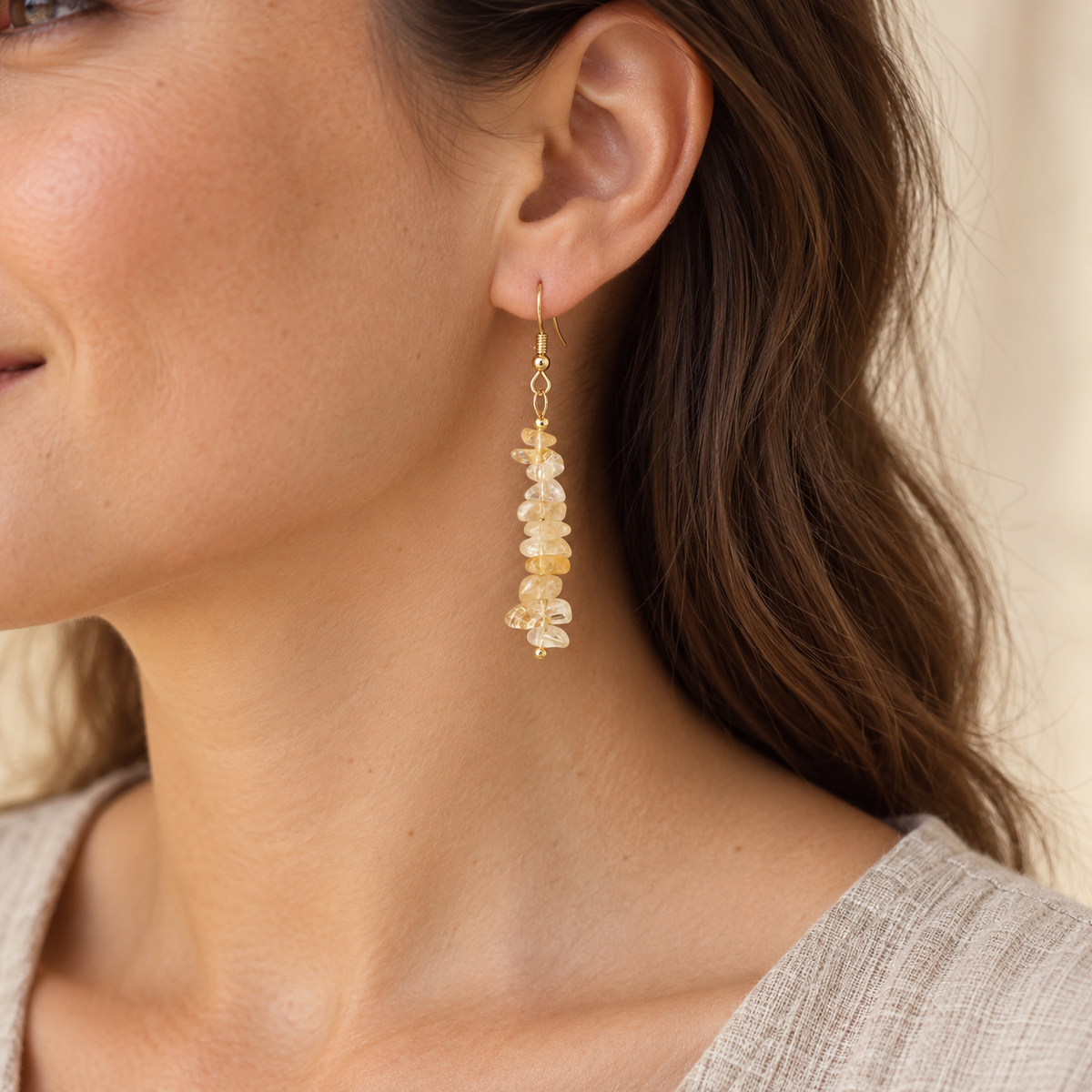 Model wearing Citrine stone chip drop earrings with gold-tone hooks.
