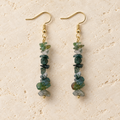 Moss Agate stone chip drop earrings with gold-tone hooks on a warm cream background.