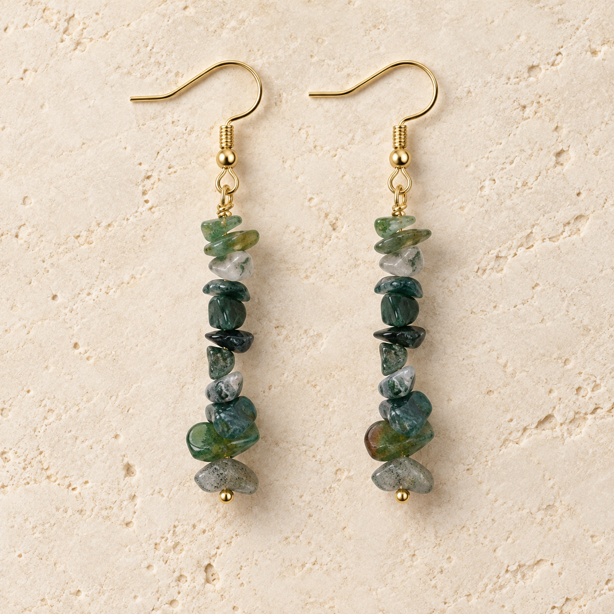 Moss Agate stone chip drop earrings with gold-tone hooks on a warm cream background.
