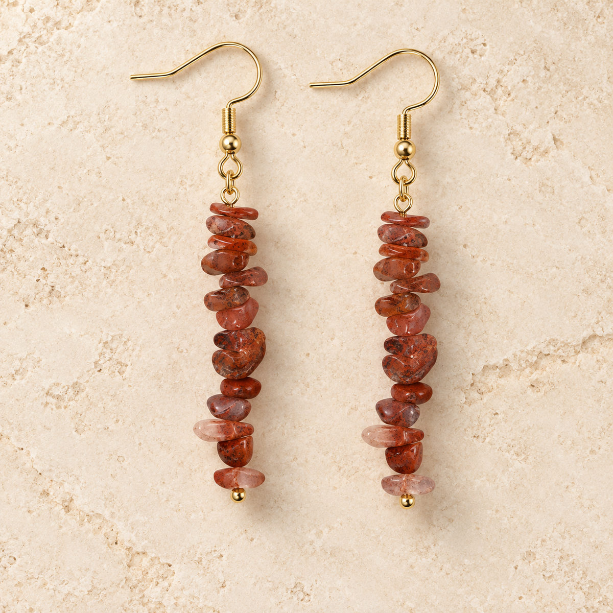 Red Jasper stone chip drop earrings with gold-tone hooks on a warm cream background.