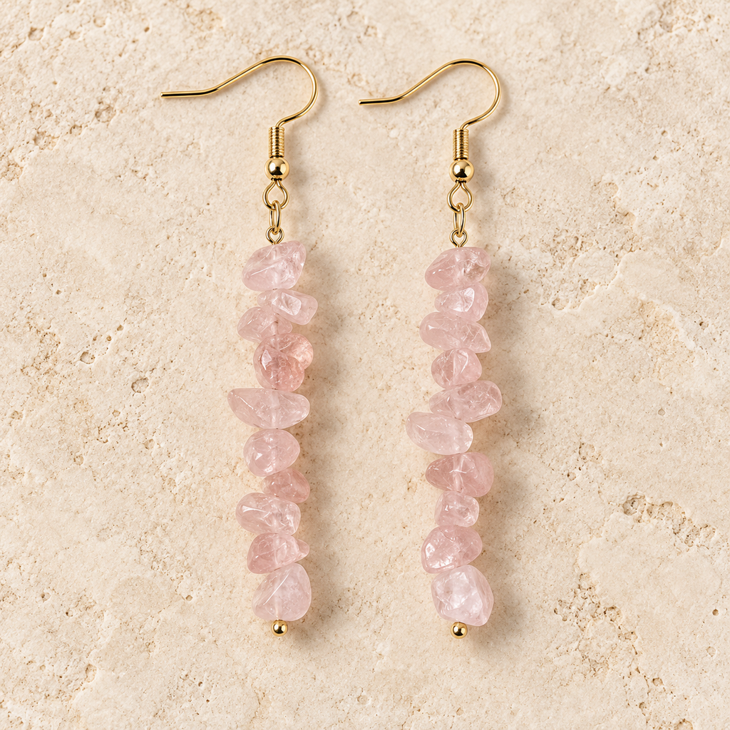 Rose Quartz stone chip drop earrings with gold-tone hooks on a warm cream background.