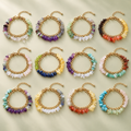 Twelve gold-tone gemstone chip bracelets representing the twelve astrological signs