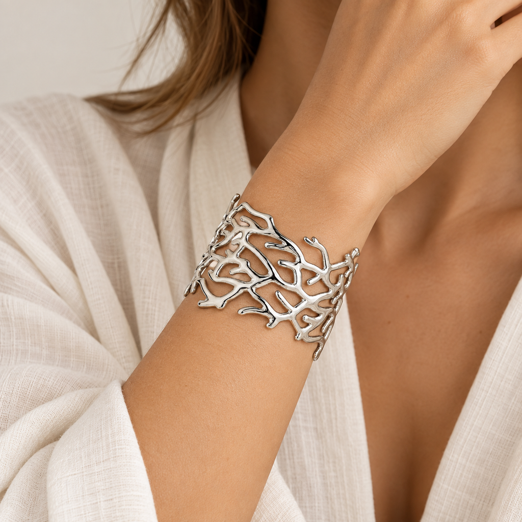 Model wearing the Sacred Root Cuff Bracelet in polished silver