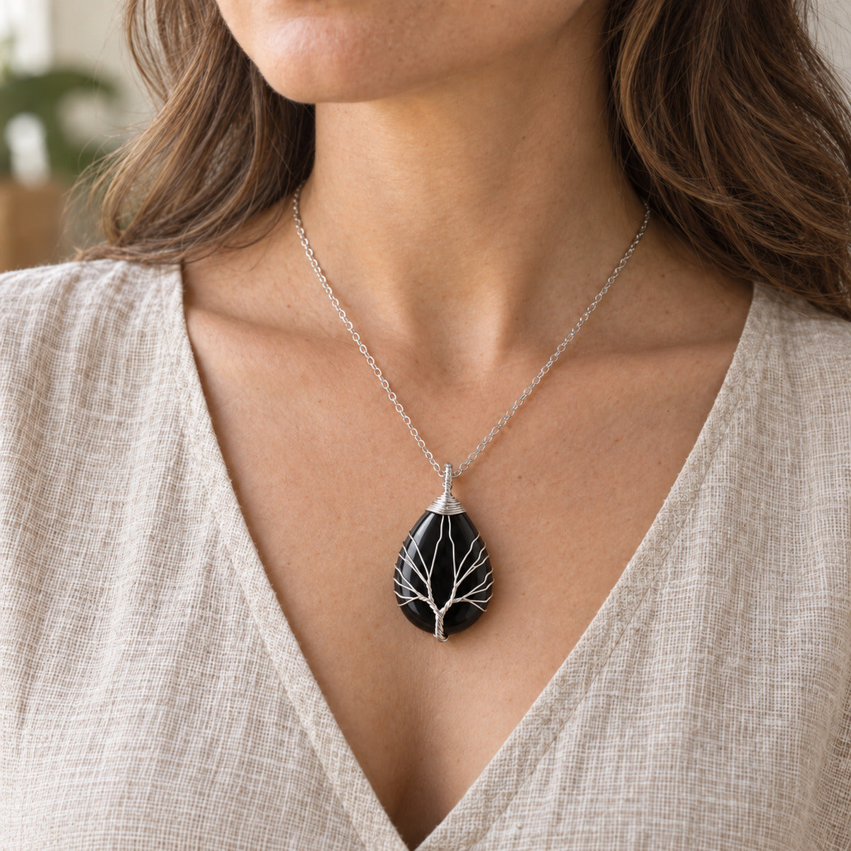 Model wearing the Obsidian teardrop Tree of Life necklace.
