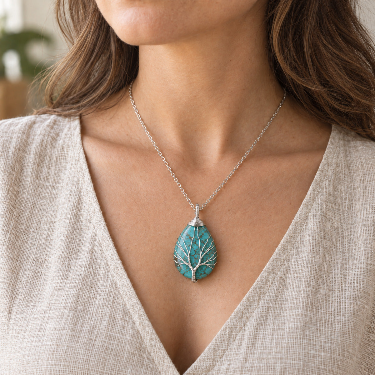 Model wearing the Turquoise teardrop Tree of Life necklace.