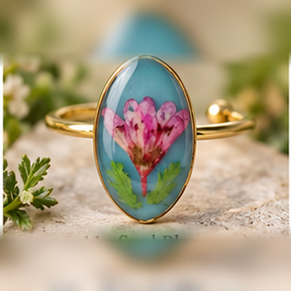 Soul Bloom adjustable stainless steel pressed-flower ring with a pink bloom on turquoise.