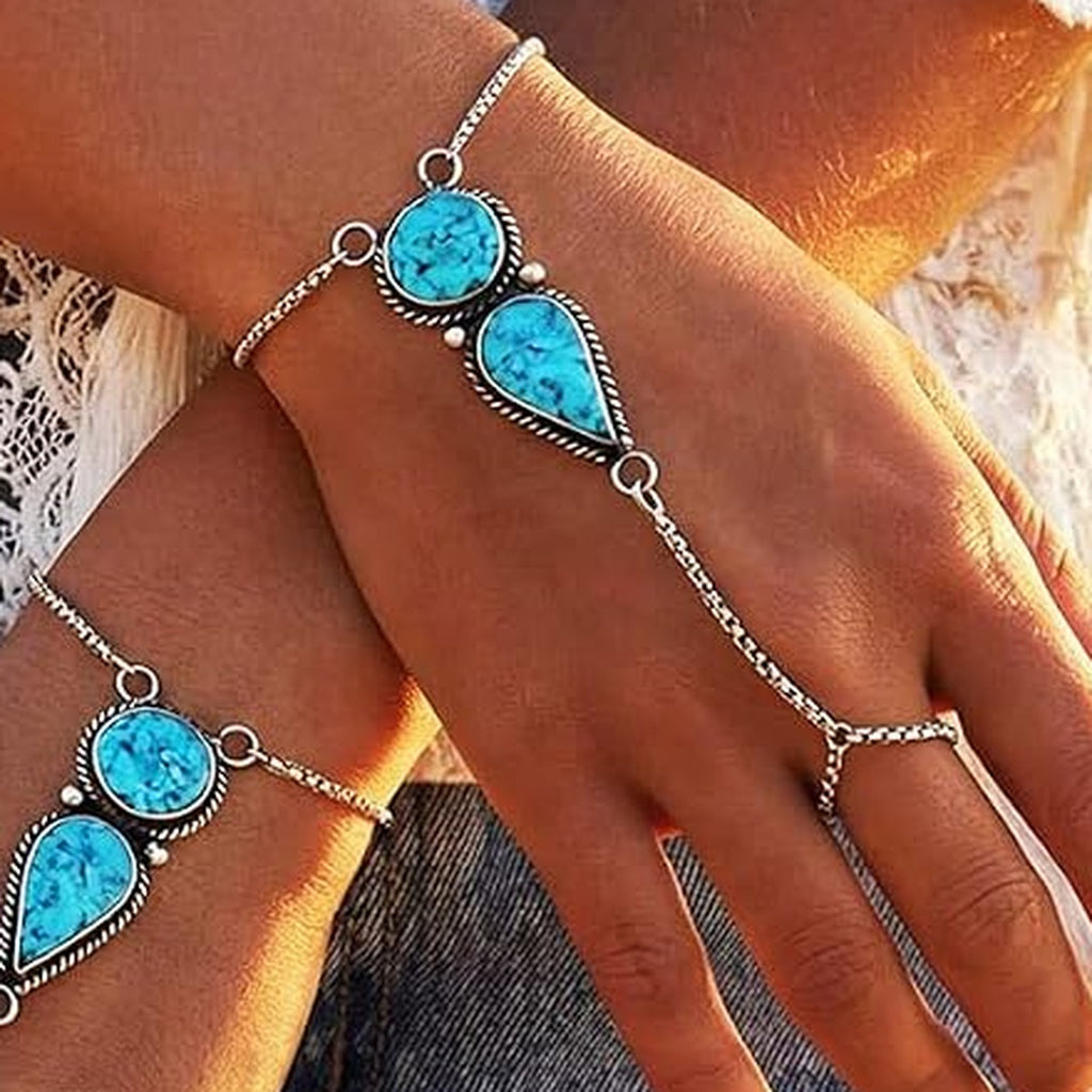 Close-up of turquoise stones on silver-tone hand chain bracelet