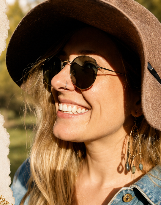 Meg smiling outdoors wearing handmade jewelry