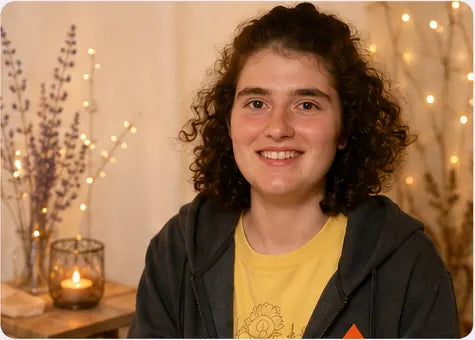 Zoe smiling in a warm creative setting